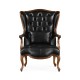 Wing-backed chair in black leather