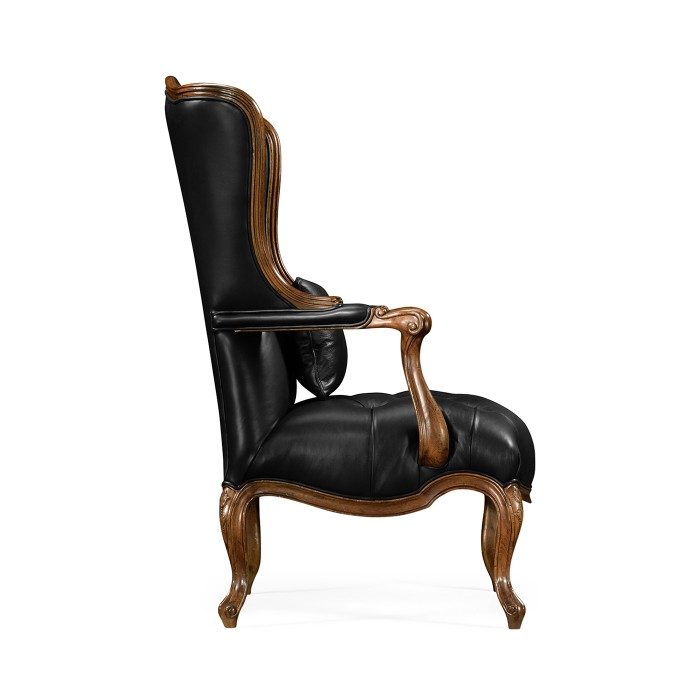 Wing-backed chair in black leather