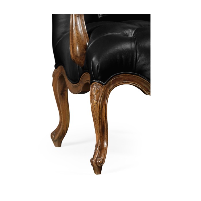 Wing-backed chair in black leather
