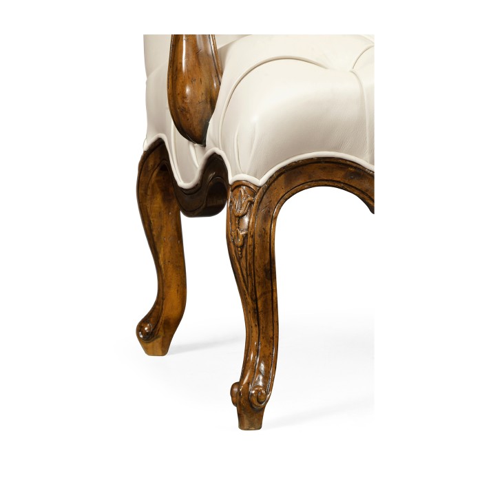Wing-backed chair in cream leather